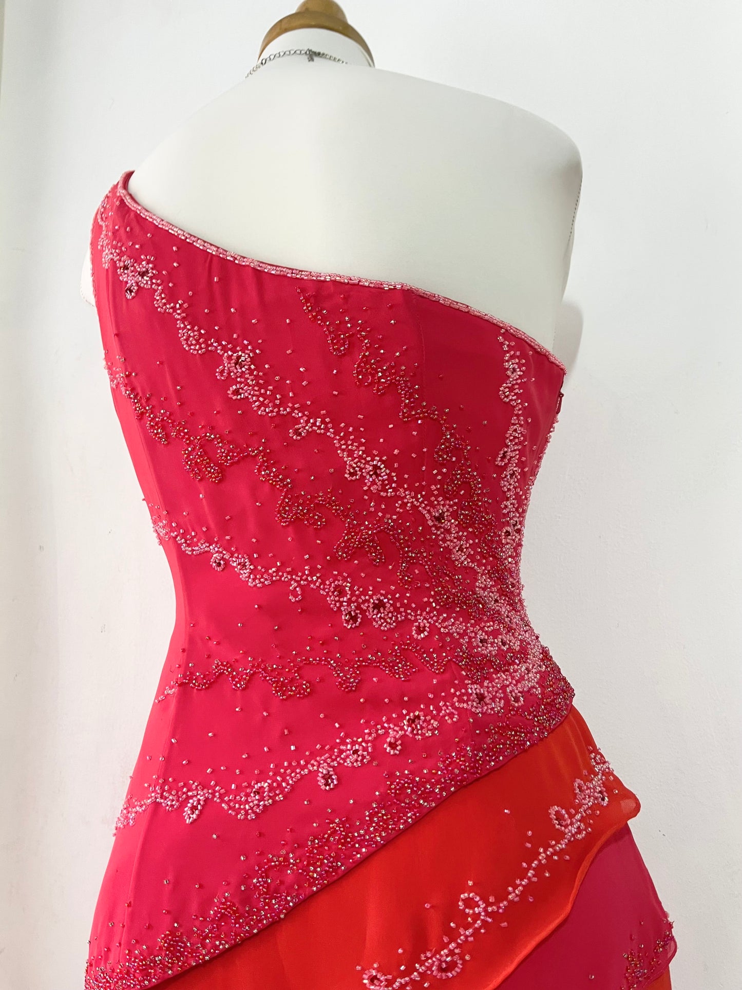 Asymmetrical raspberry and coral dress with exquisite handmade raised floral embroidery