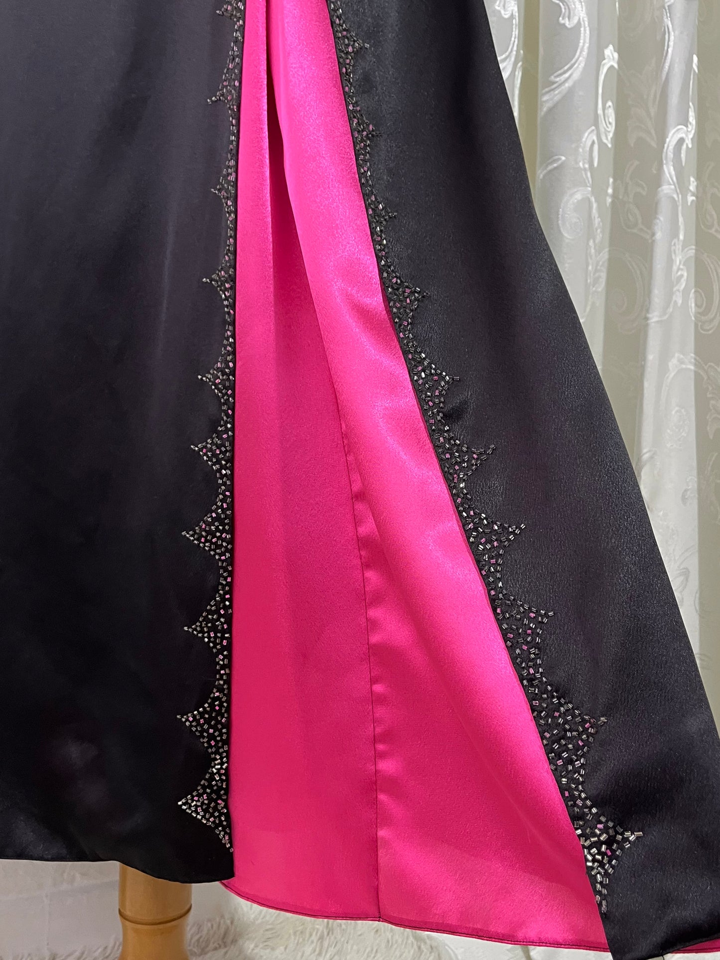 Noir corset dress with fuchsia side slit, sequin details and hand-embroidered embellishments
