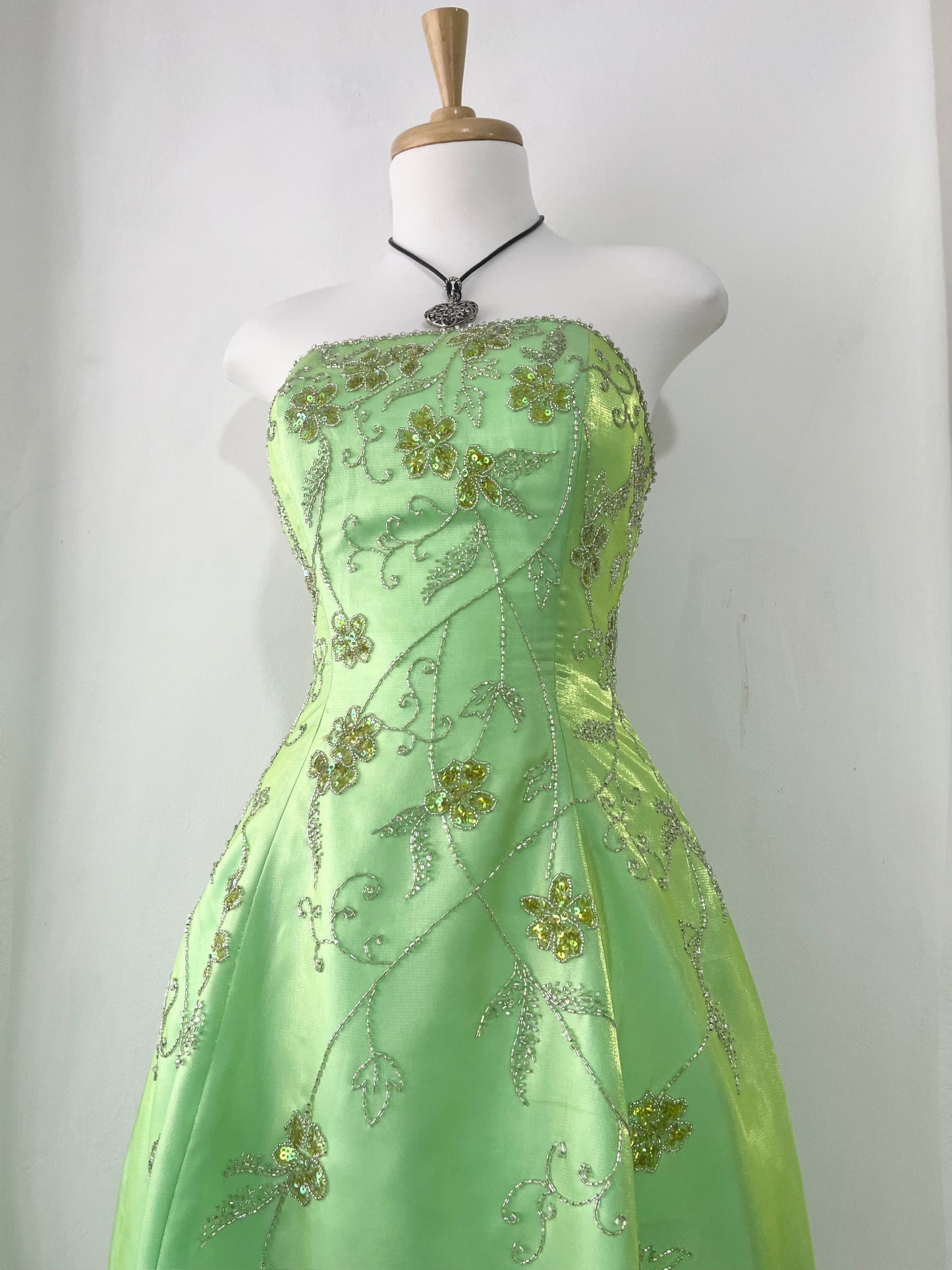 Corset gown dress in a vibrant pistachio green with exquisite handmade raised floral embroidery