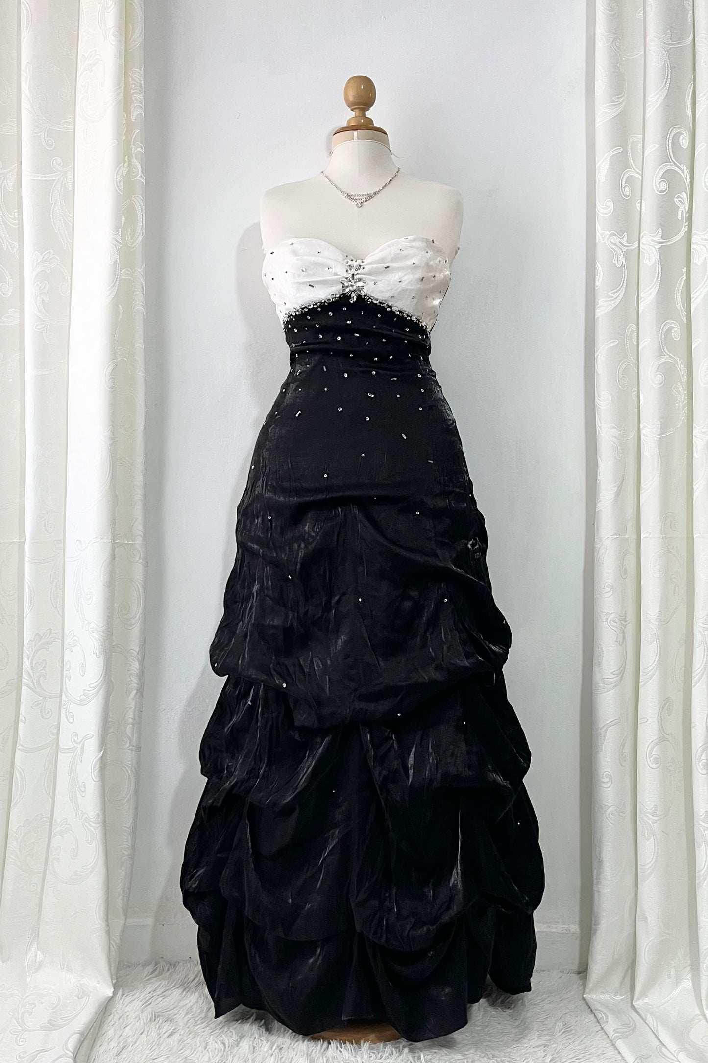 Noir and ivory gown with a skirt featuring gathered details, rhinestone appliqués, and sparkling embellishments.- size M/L