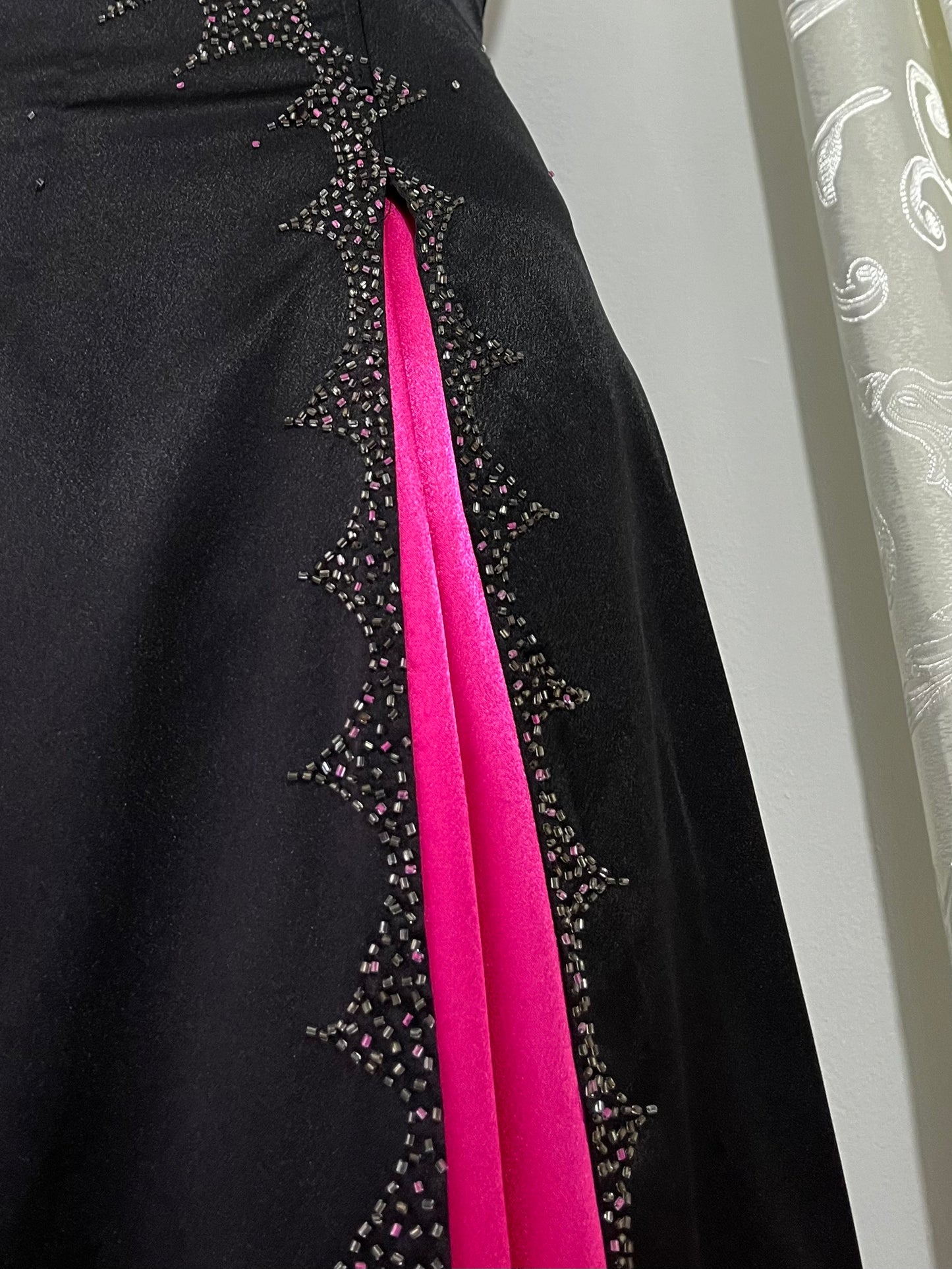 Noir corset dress with fuchsia side slit, sequin details and hand-embroidered embellishments