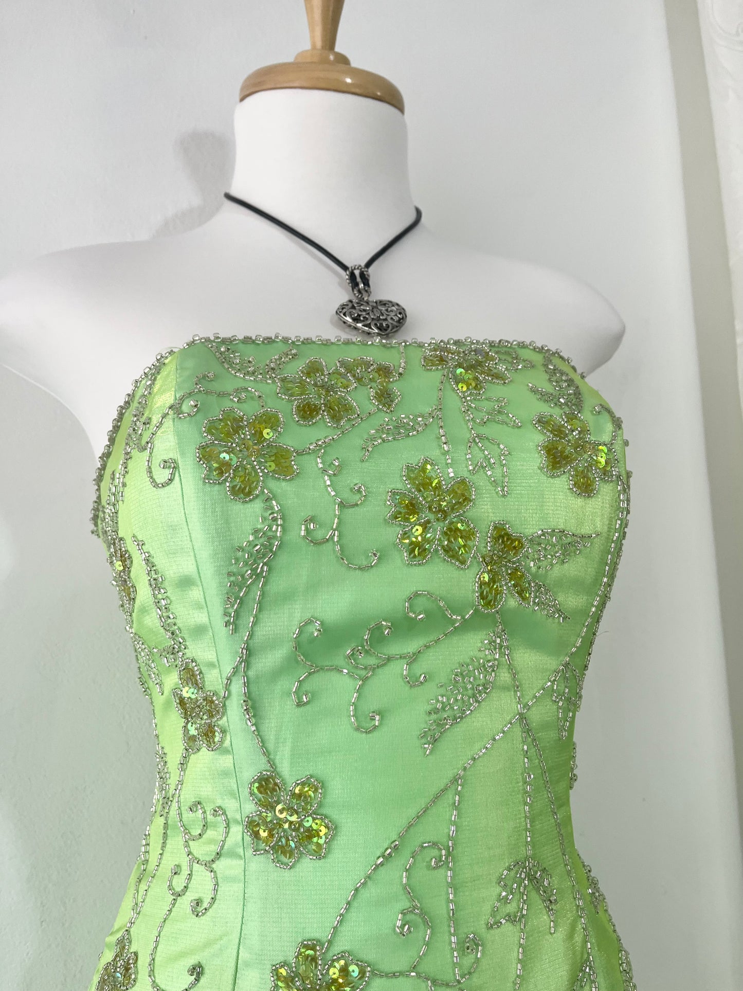 Corset gown dress in a vibrant pistachio green with exquisite handmade raised floral embroidery