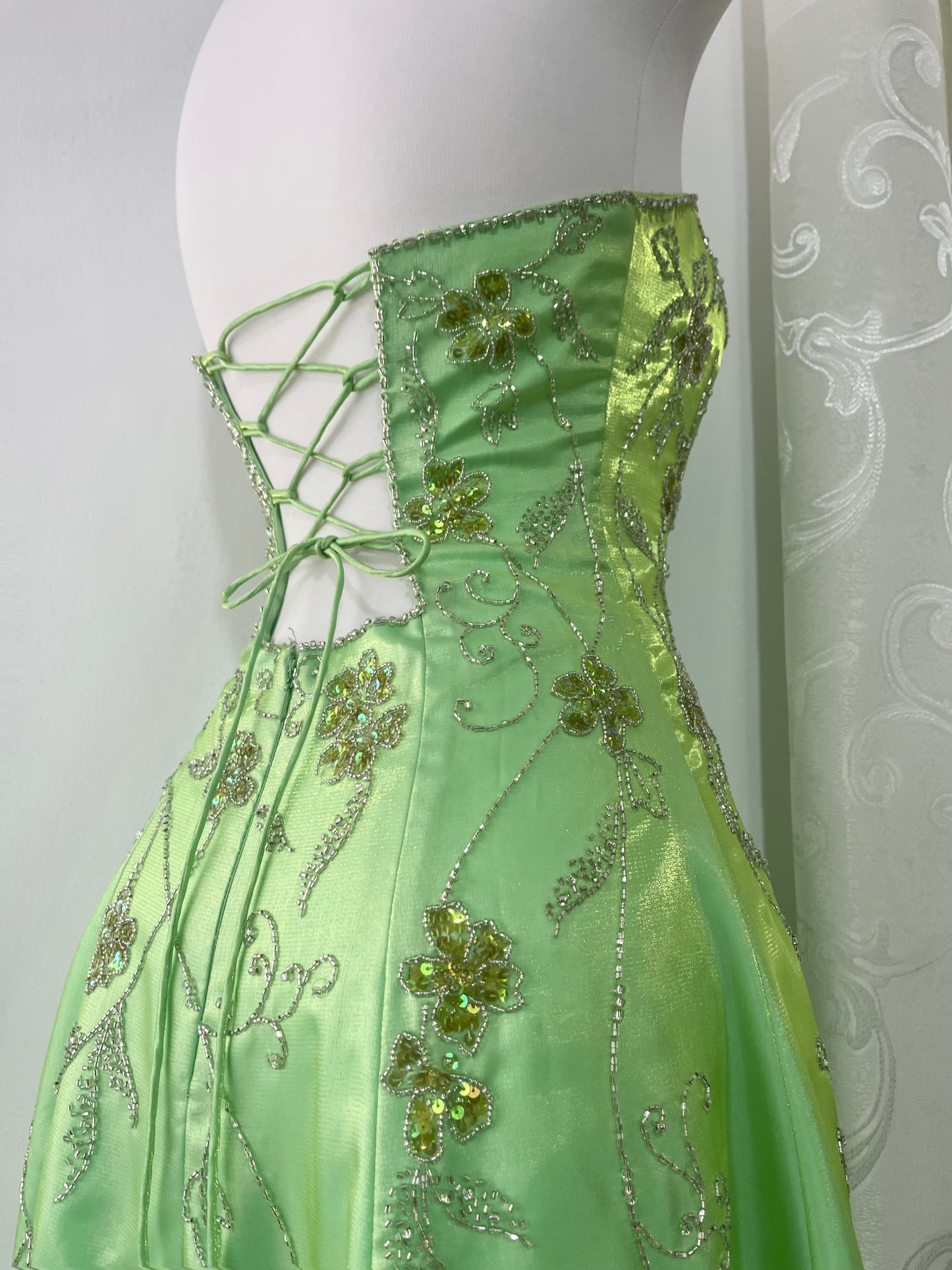 Corset gown dress in a vibrant pistachio green with exquisite handmade raised floral embroidery