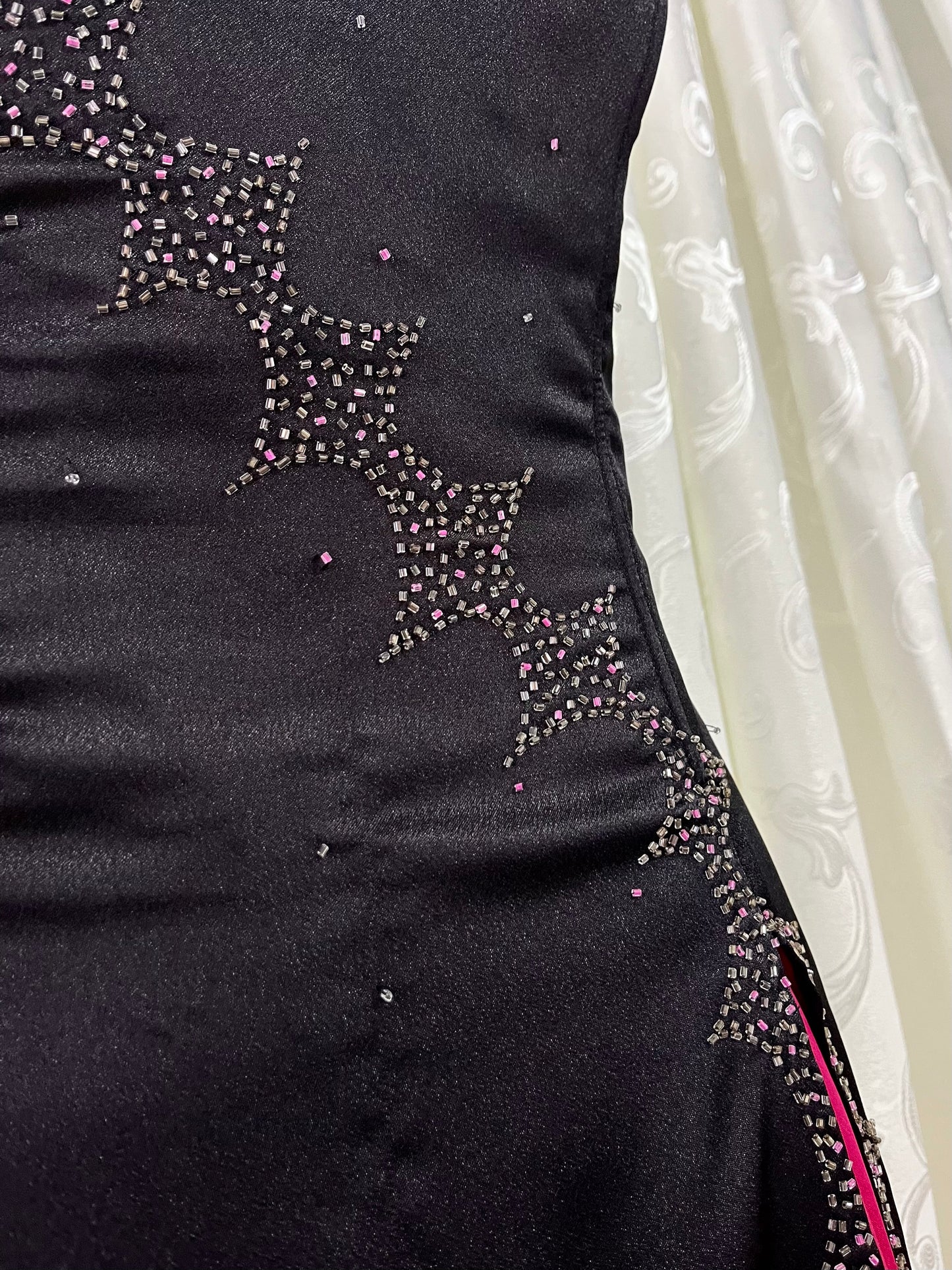 Noir corset dress with fuchsia side slit, sequin details and hand-embroidered embellishments