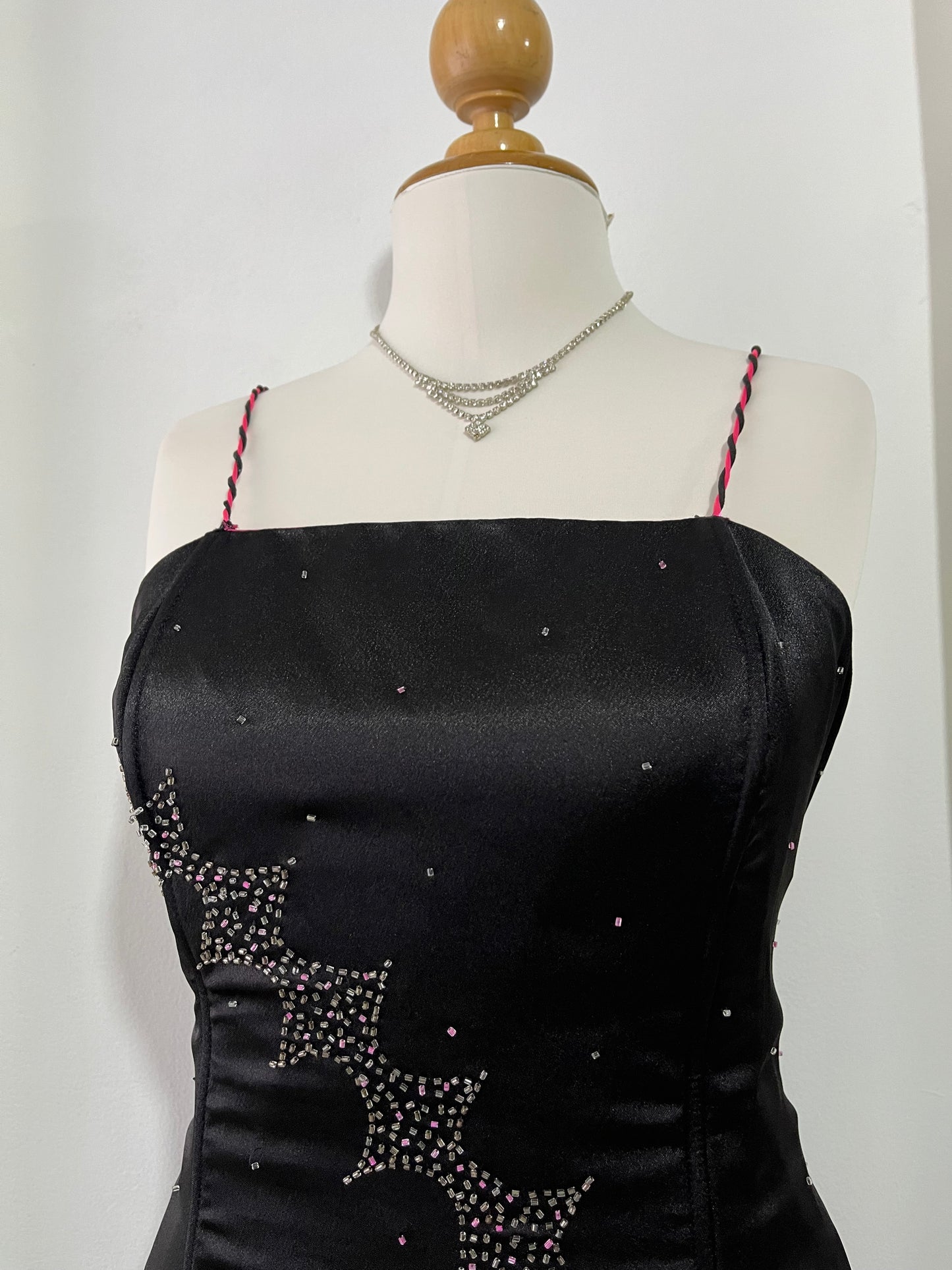 Noir corset dress with fuchsia side slit, sequin details and hand-embroidered embellishments