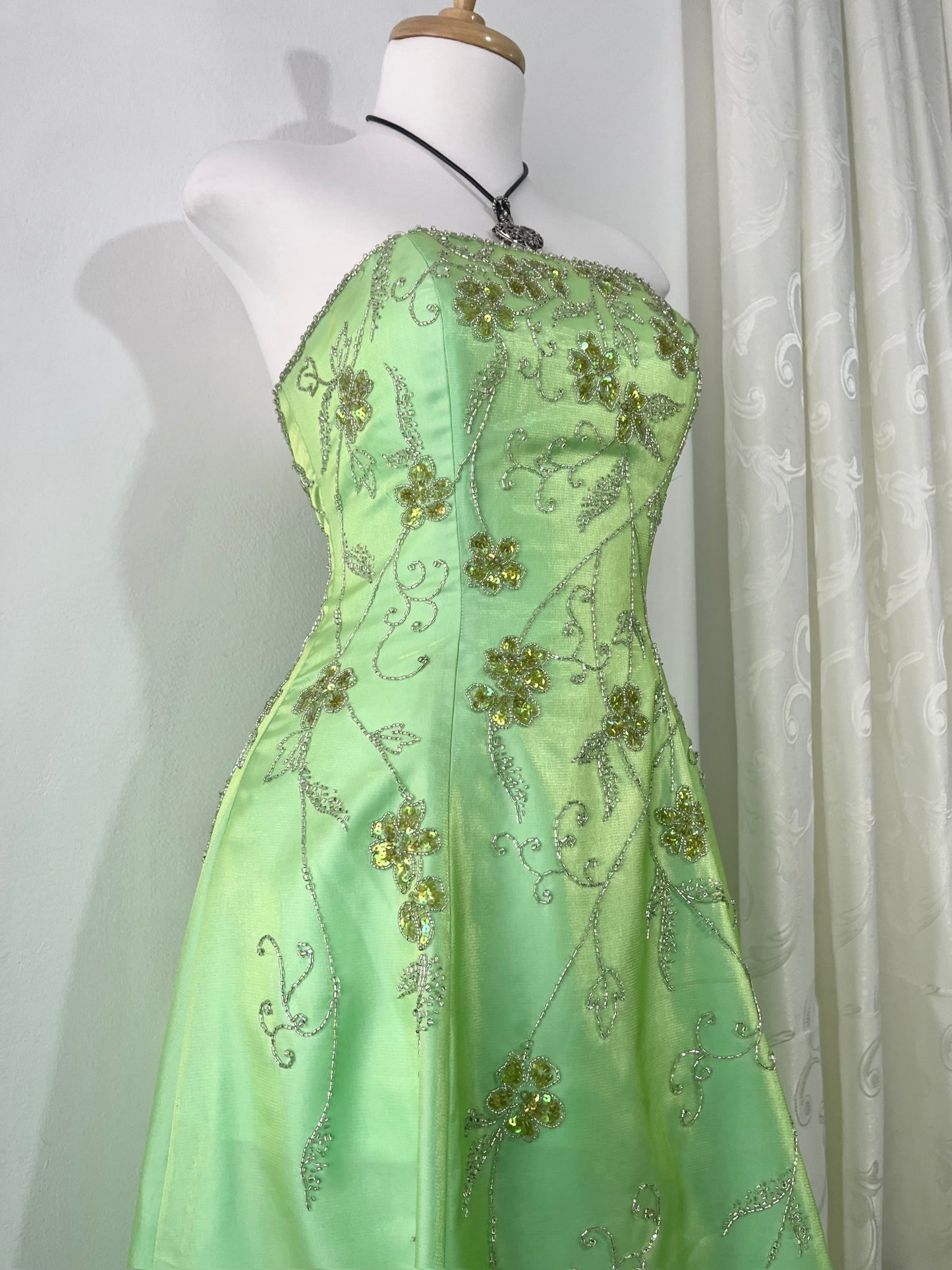Corset gown dress in a vibrant pistachio green with exquisite handmade raised floral embroidery