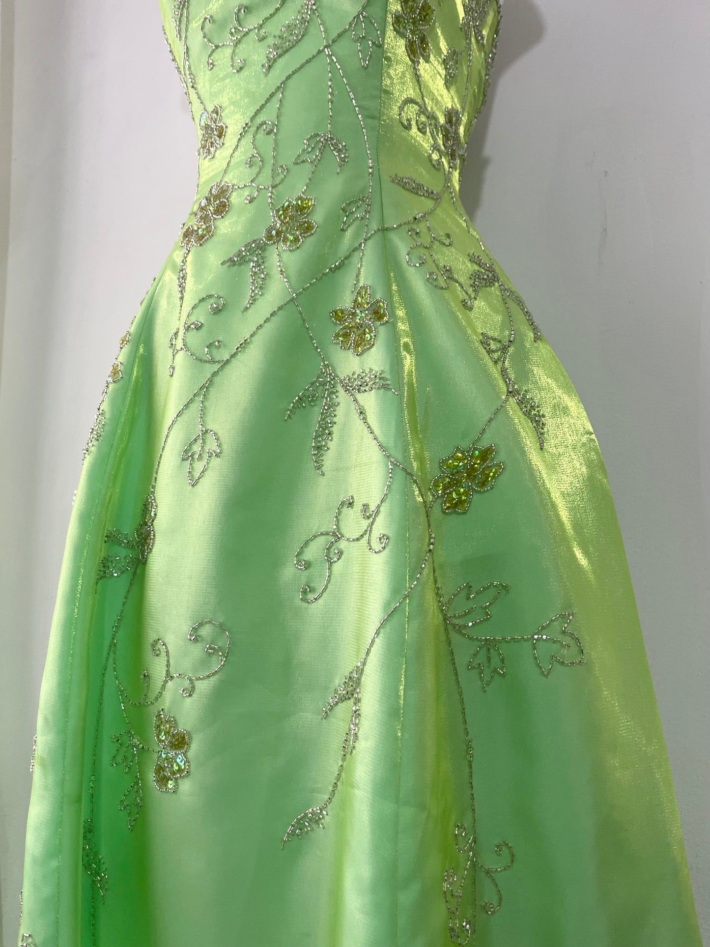 Corset gown dress in a vibrant pistachio green with exquisite handmade raised floral embroidery