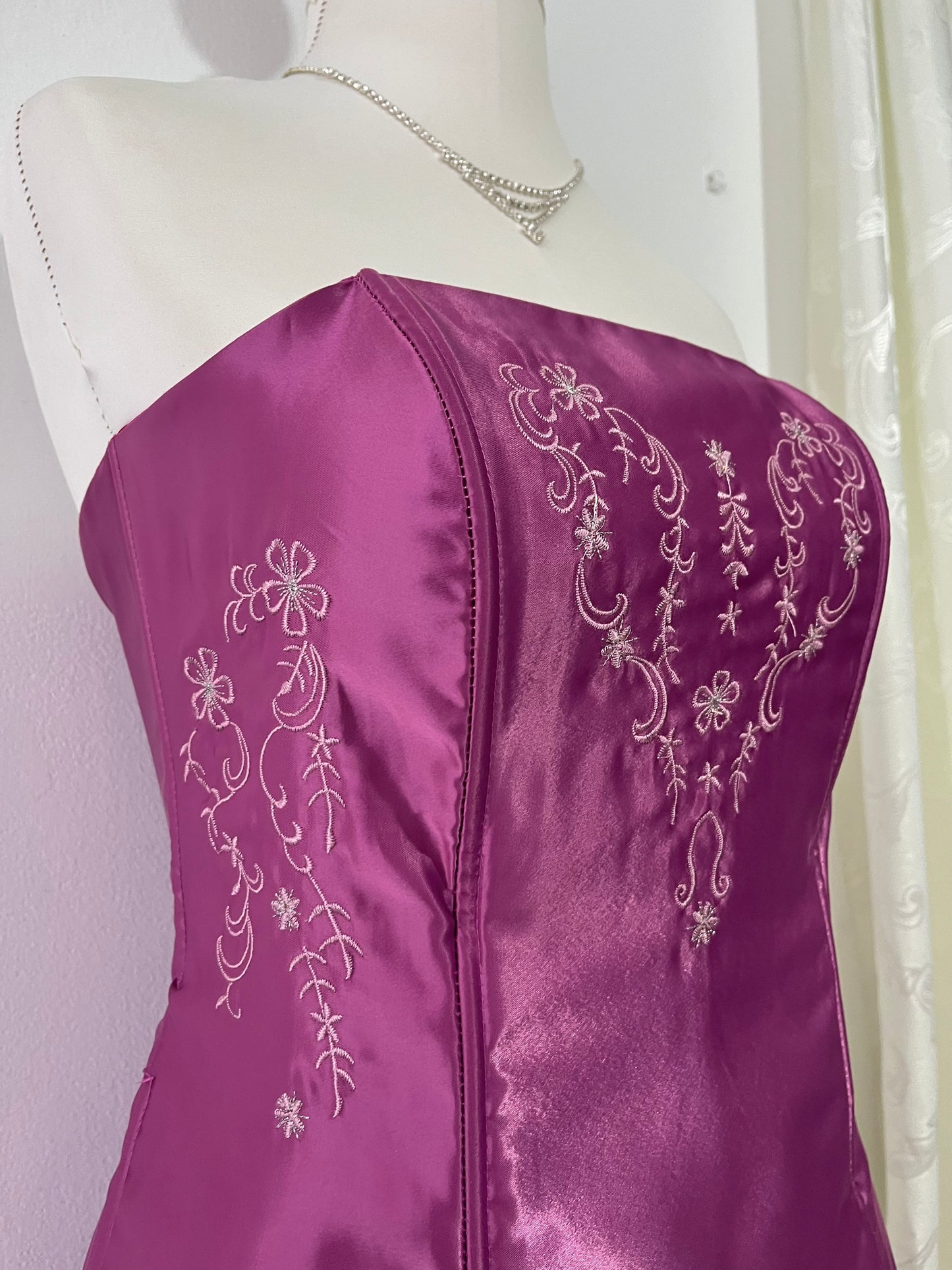 Magenta corset dress with floral designs embroidered in lilac and silver thread
