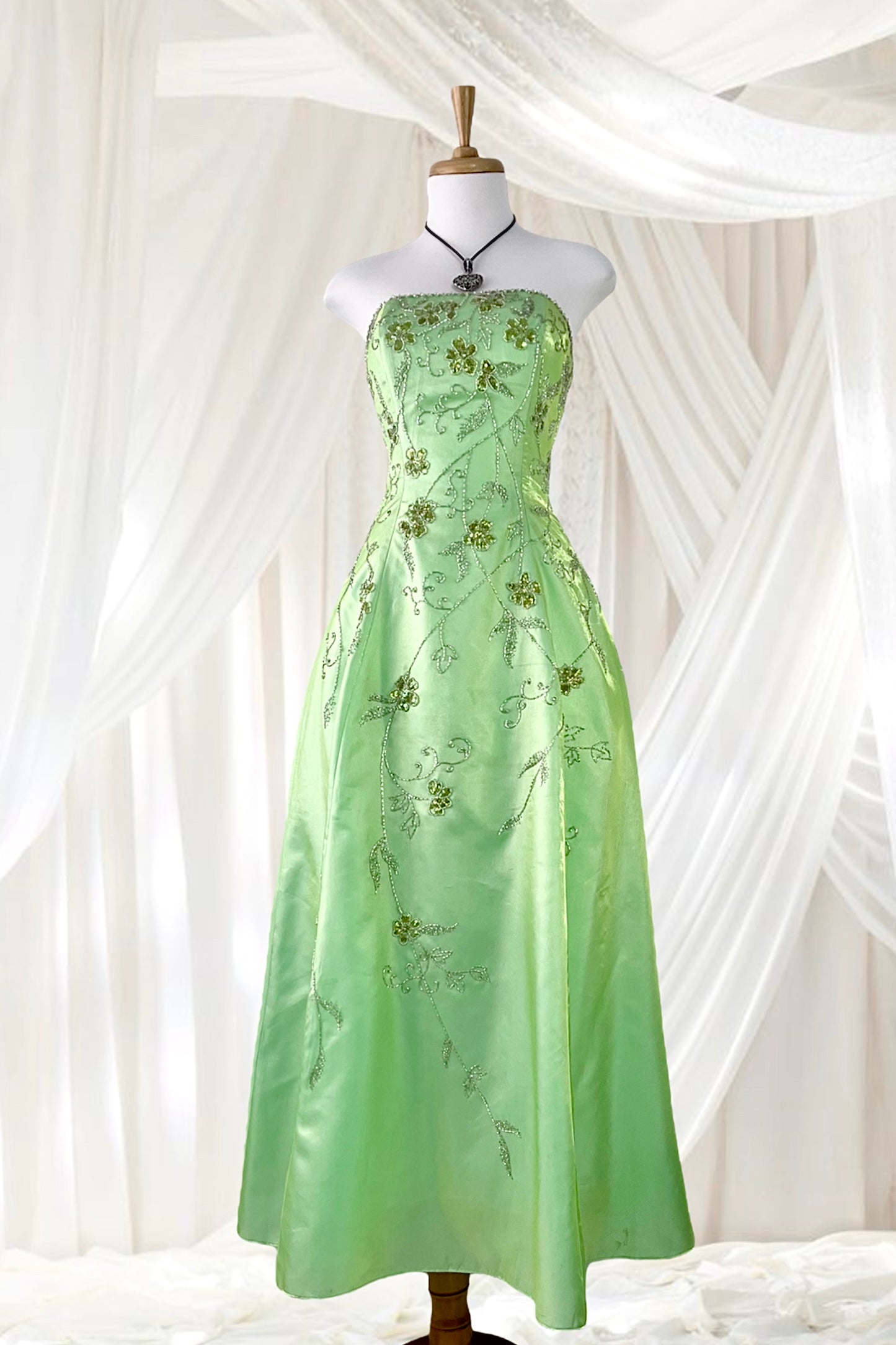 Corset gown dress in a vibrant pistachio green with exquisite handmade raised floral embroidery