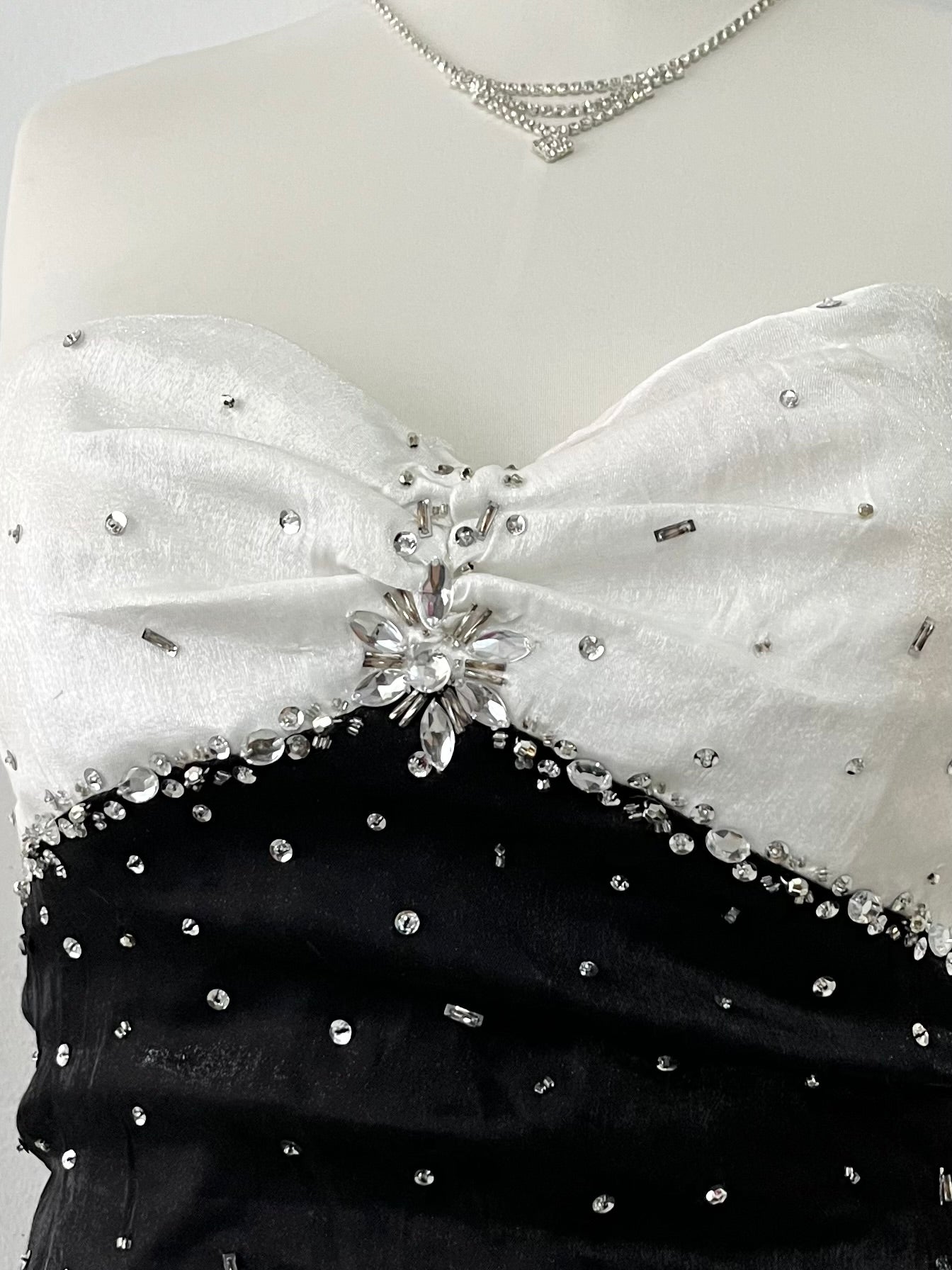 Noir and ivory gown with a skirt featuring gathered details, rhinestone appliqués, and sparkling embellishments.- size M/L