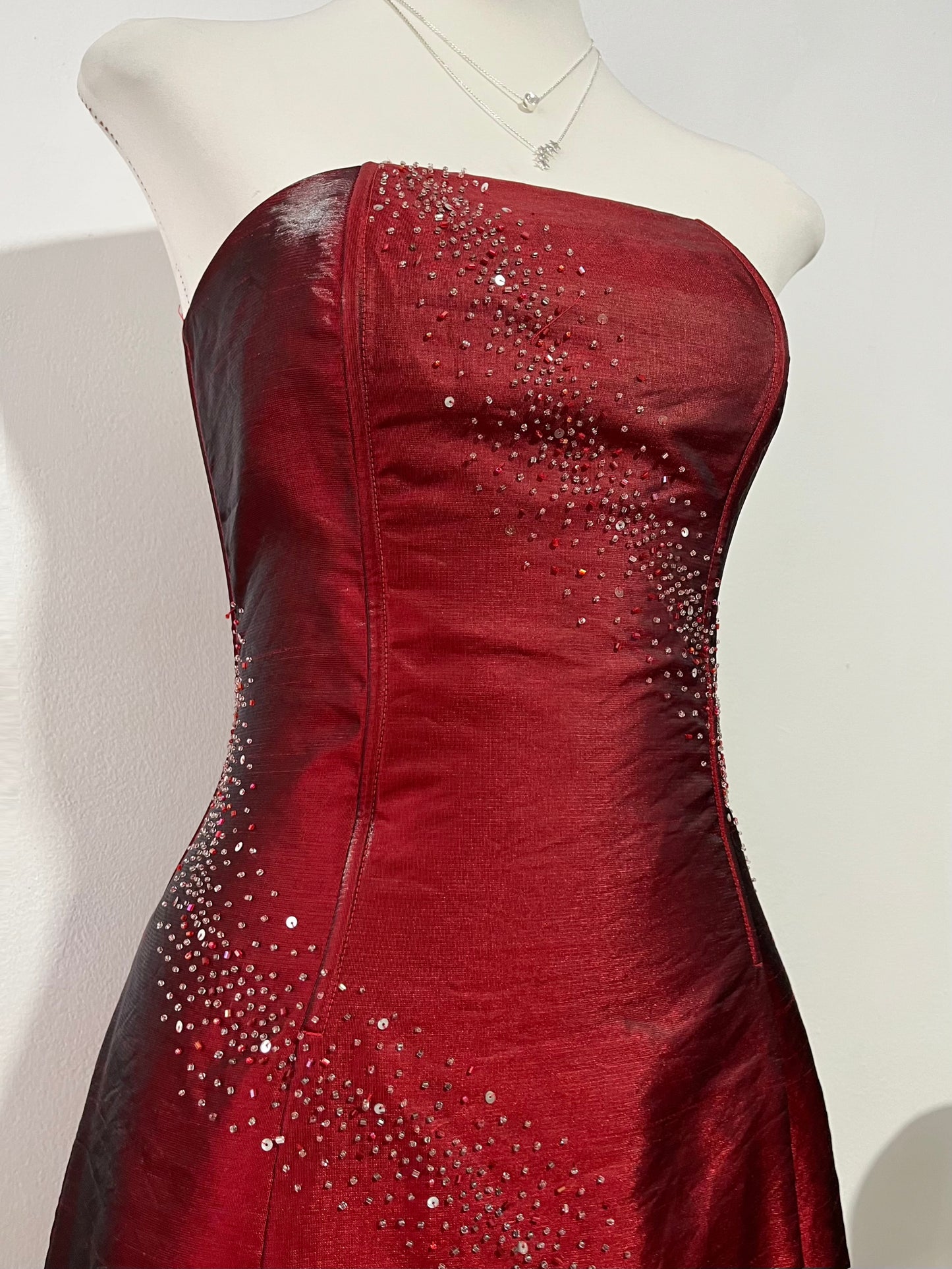 Strapless corset dress in crimson burgundy taffeta with hand-embroidered rhinestones and embellishments