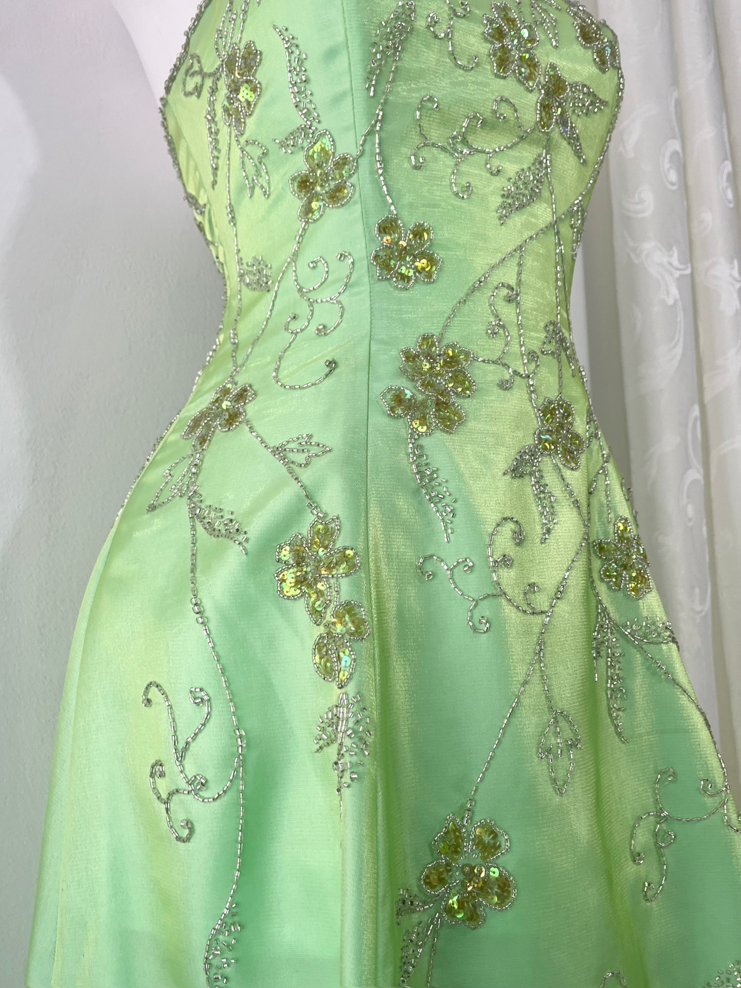 Corset gown dress in a vibrant pistachio green with exquisite handmade raised floral embroidery