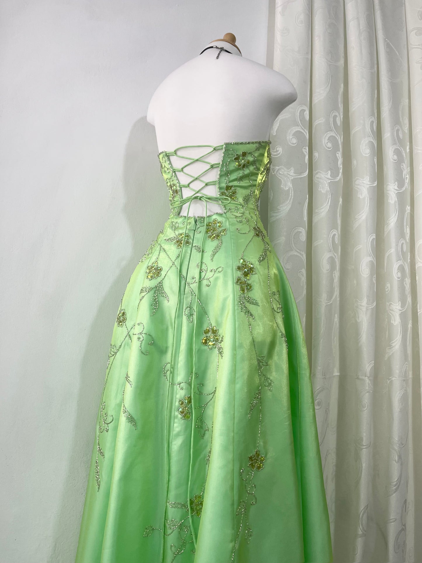 Corset gown dress in a vibrant pistachio green with exquisite handmade raised floral embroidery