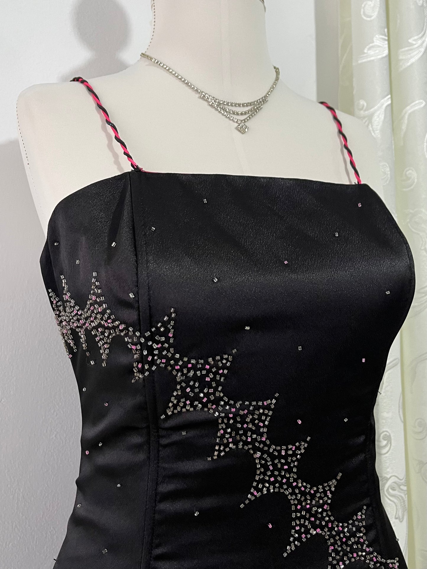 Noir corset dress with fuchsia side slit, sequin details and hand-embroidered embellishments