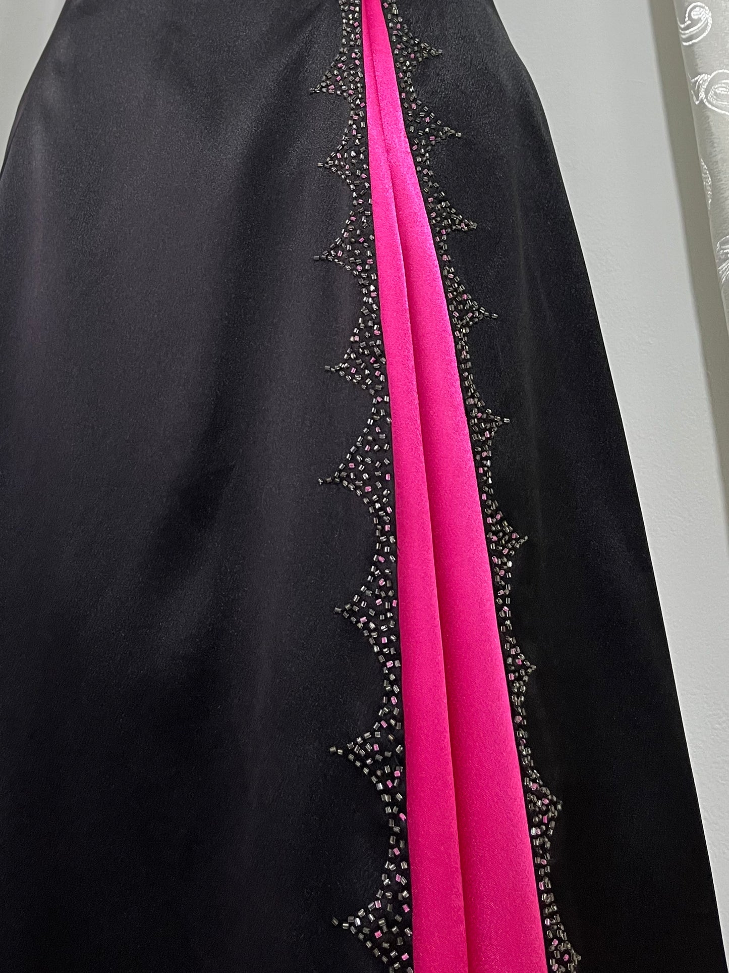 Noir corset dress with fuchsia side slit, sequin details and hand-embroidered embellishments
