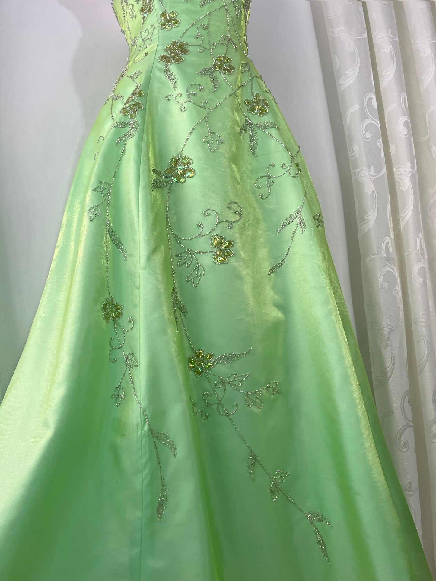 Corset gown dress in a vibrant pistachio green with exquisite handmade raised floral embroidery