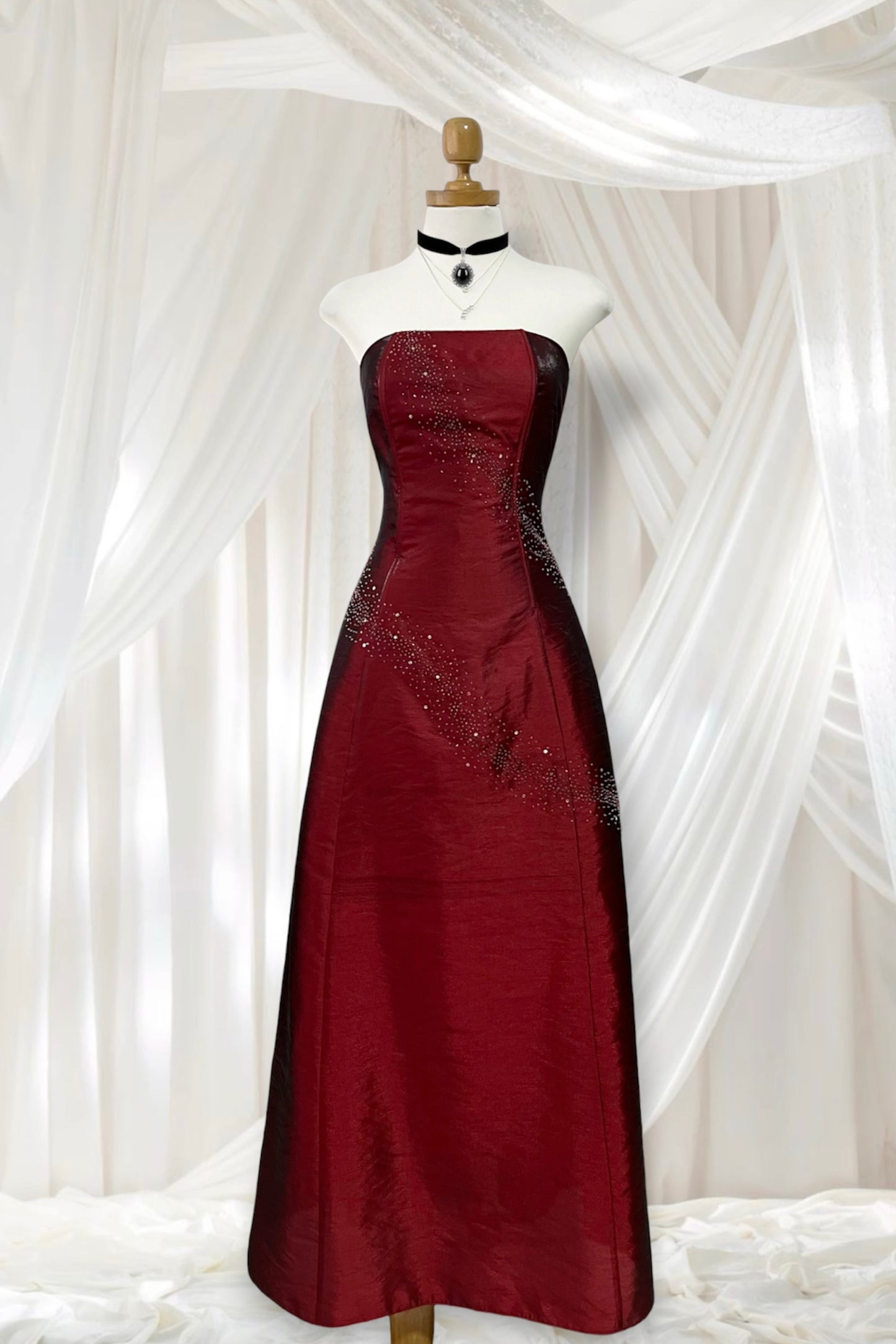 Strapless corset dress in crimson burgundy taffeta with hand-embroidered rhinestones and embellishments