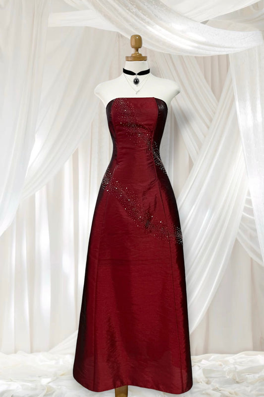 Strapless corset dress in crimson burgundy taffeta with hand-embroidered rhinestones and embellishments