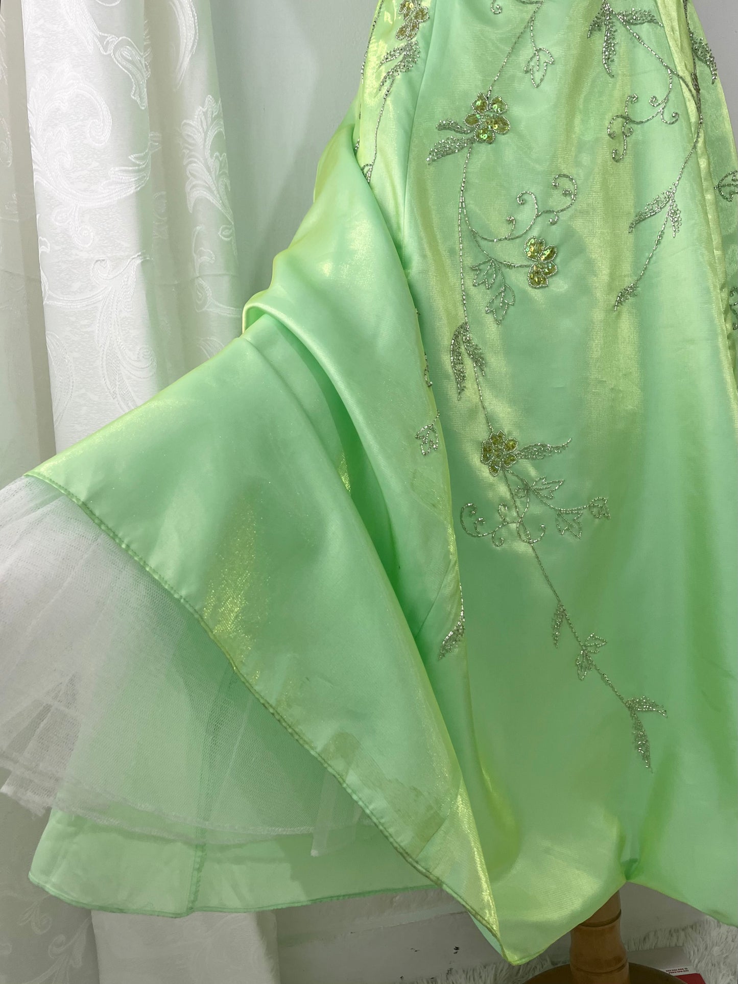 Corset gown dress in a vibrant pistachio green with exquisite handmade raised floral embroidery