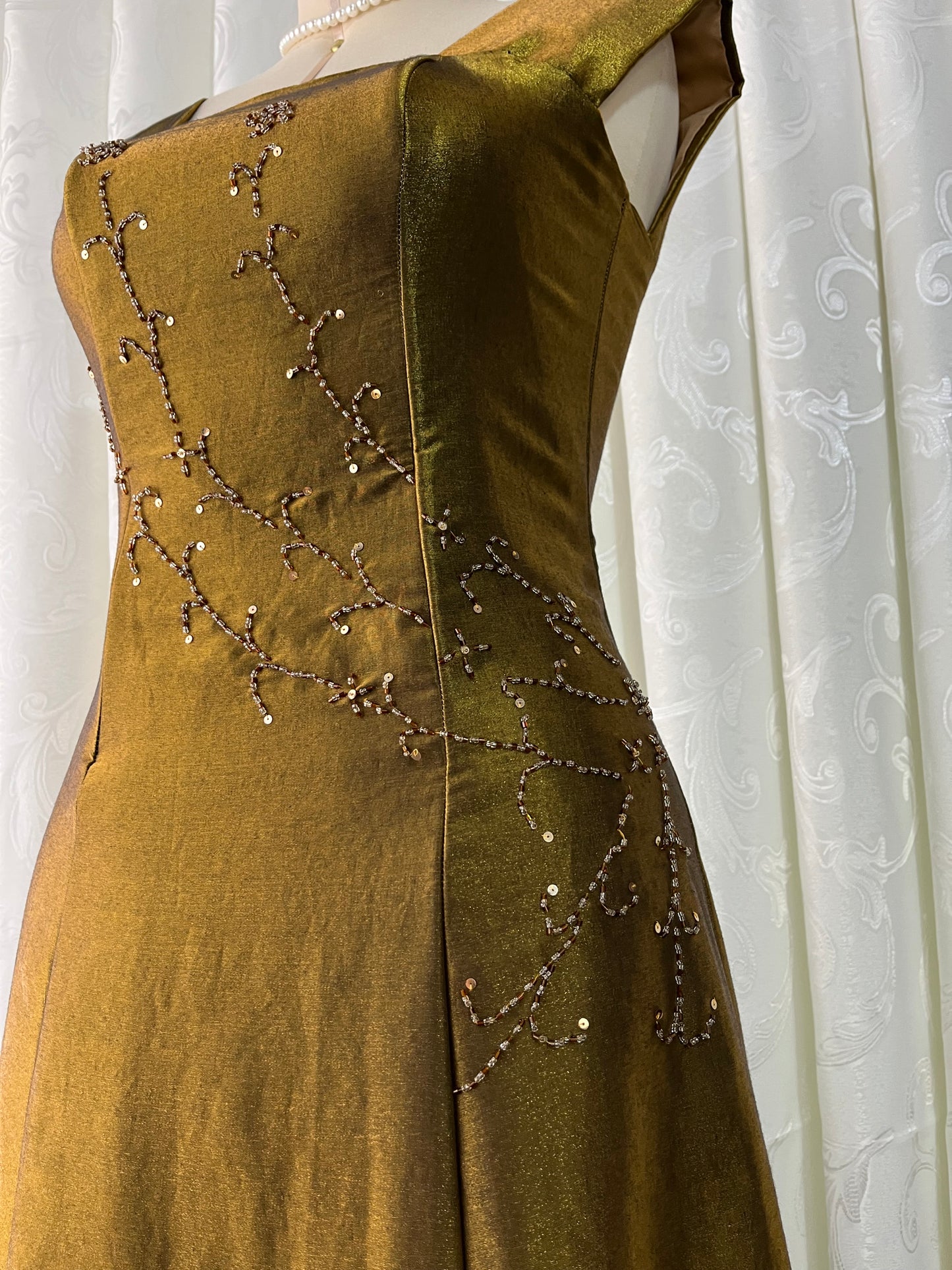 Iridescent brooch dress with fine bead embroidery